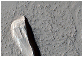 Strmlinjeformade formationer och en krater i Amazonis Planitia