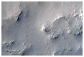 Crater in Dust Mantled Landscape