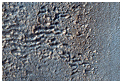 Remains of Layers along Wall of Crater South of Reull Vallis