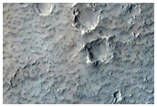 Sinuous Ridge Materials Downslope from Fan in Reuyl Crater