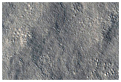 Mid-Latitude Crater with Black Spot in Center