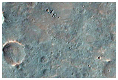Distorted Transverse Aeolian Ridges in Small Craters in Sinai Planum