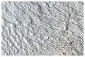 Layers at Edge of Pedestal Crater in Tikhonravov Crater