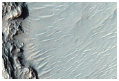 Layered Material Exposed in Pit on Crater Floor