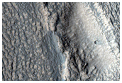 Tongue-Shaped Landform in Contact with Raised Crater Rim