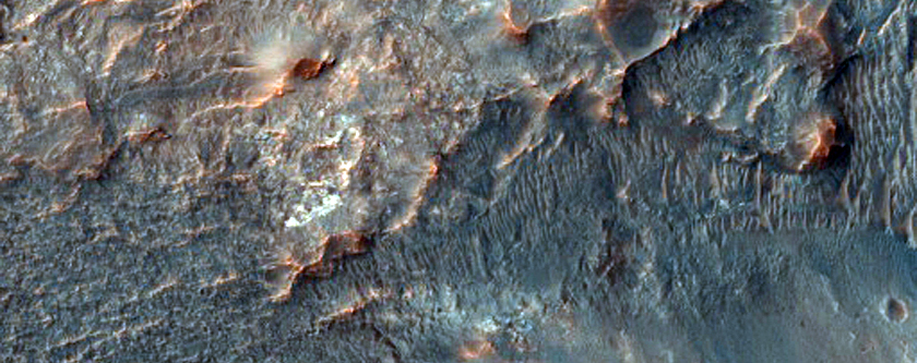 Crater with Radial Ridges and Light-Toned Exposures
