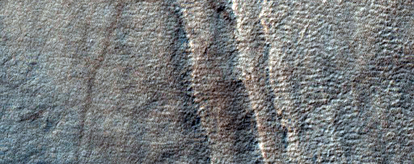 Exposure of Layers at Edge of Pedestal Crater in Malea Planum