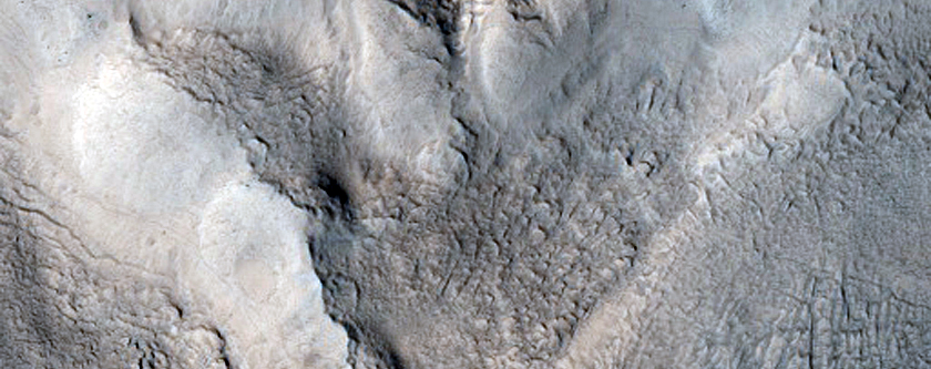 Exposed Crater Wall with Possible Flowing Material Deposits
