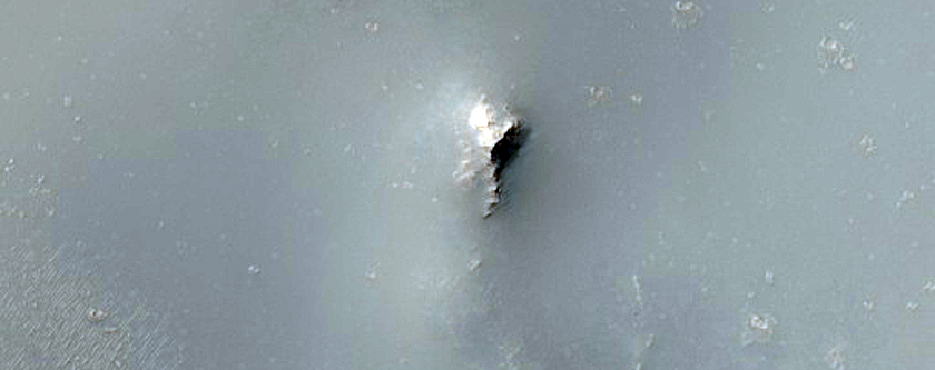 Crater Intersecting Degraded Impact Basin Rim