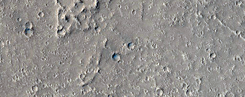 Flows and Depressions in Wind Streak Southwest of Tombaugh Crater
