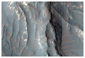Light-Toned Deposits Exposed along Floor of Terra Sabaea Crater