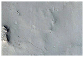 Cratered Mesa-Forming Material at Entrance of Valley into Depression