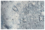 Pasted-on Material on Crater Ejecta