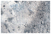 Pasted-on Material on Crater Ejecta