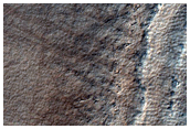 Exposure of Layers at Edge of Pedestal Crater in Malea Planum