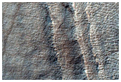 Exposure of Layers at Edge of Pedestal Crater in Malea Planum