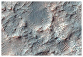 Crater with Radial Ridges and Light-Toned Exposures