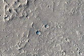 Flows and Depressions in Wind Streak Southwest of Tombaugh Crater
