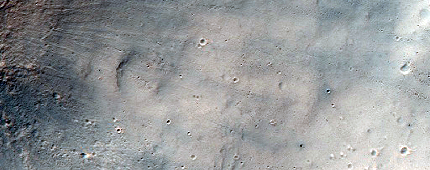 Fresh Impact Crater with Asymmetric Ejecta
