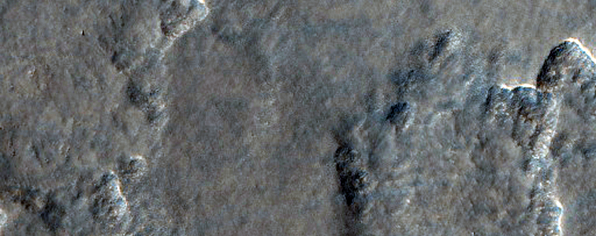 Smooth and Knobby Terrain in Lyot Crater Ejecta
