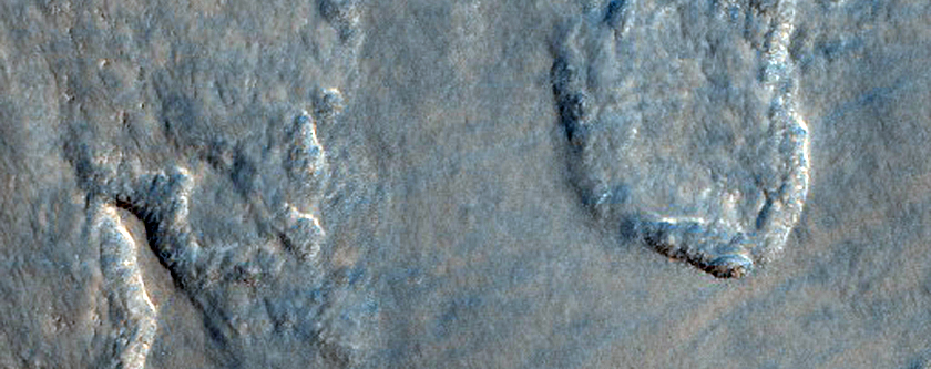 Smooth and Knobby Terrain in Lyot Crater Ejecta