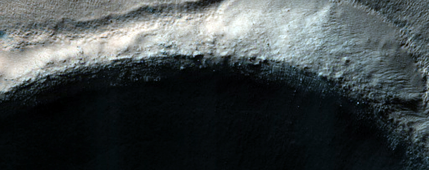 Dark Spot with Light-Toned Outline on Crater Floor