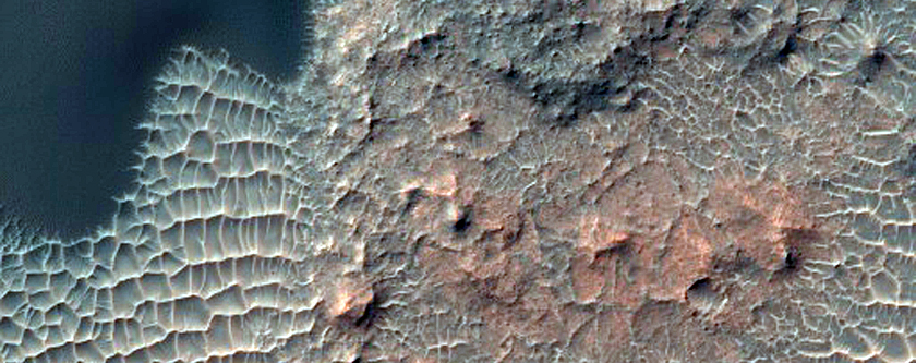 Rocky Impact Crater on the Floor of a Larger Crater
