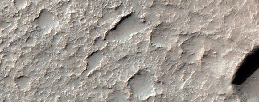 Pit on Crater Floor Exposing Layered Bedrock
