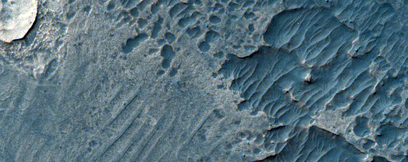 Light-Toned Deposits Exposed along Melas Chasma Northern Wall and Floor
