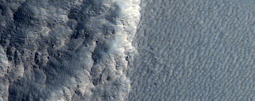 Depression with Straight Wall in Milankovic Crater
