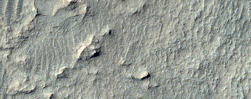 Fractured Floor Material in Crater Near Charybdis Scopulus

