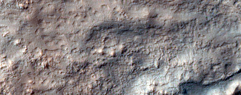 Channel-Blocking Deposit Adjacent to Impact Crater 
