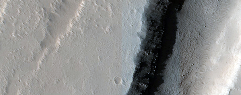 Hanging Crater Sliced by Graben in Tantalus Fossae
