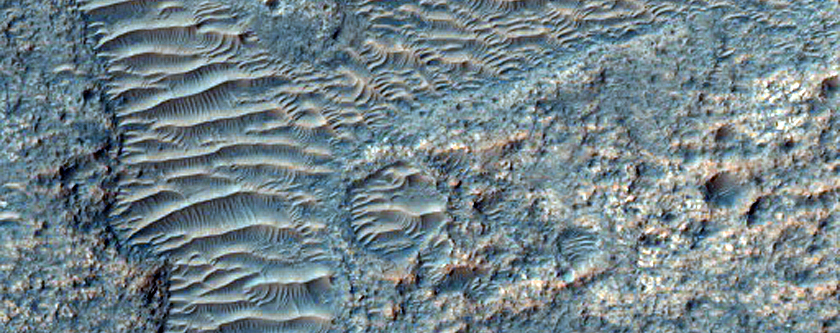 Channels and Rocky Material with Concentric Pattern on Crater Floor

