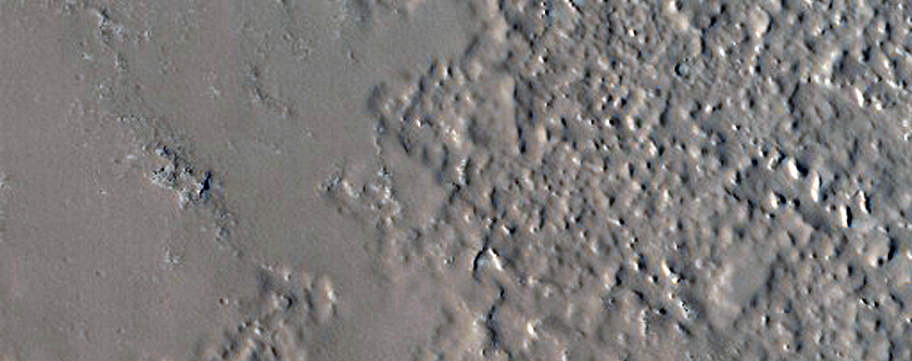 Layers in Mantle along Crater Wall Northeast of Cassini Crater
