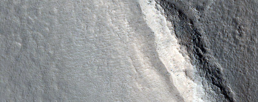 Crater in Valley Floor Material
