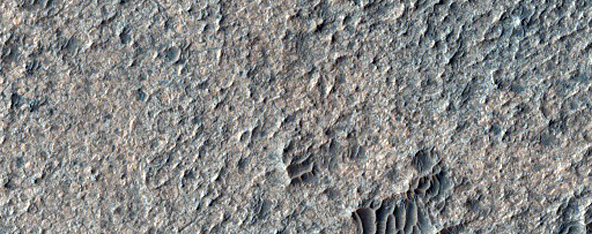 Light-Toned Material Associated with Curvilinear Landform
