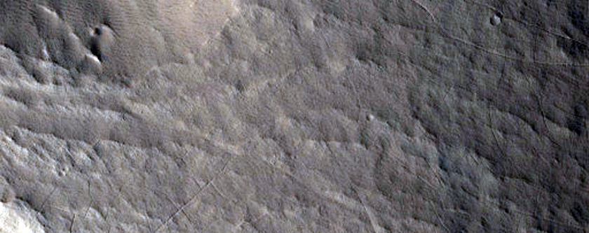 Rounded Deposit at Terminus of Valley Breaching Crater Rim
