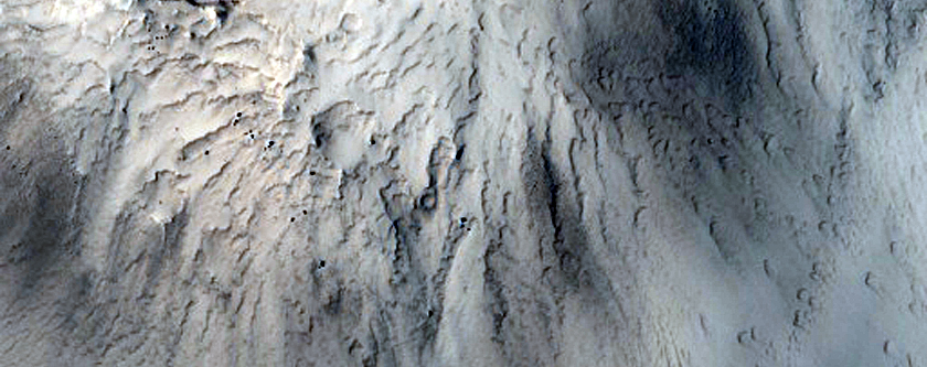 Distinct Bedrock Layer Exposed in Crater Rim North of Curie Crater
