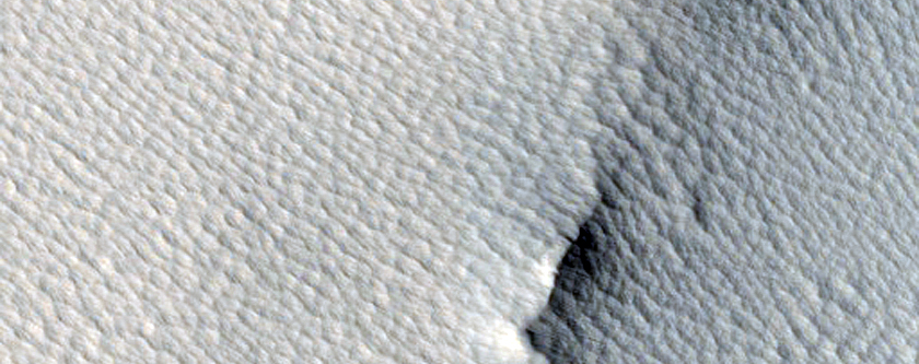 Impact Crater between Ulysses and Biblis Tholi