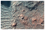 Rocky Impact Crater on the Floor of a Larger Crater
