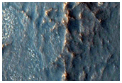 Linear Ridge Features and Possible Mounds in Lyot Crater
