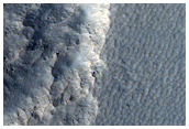 Depression with Straight Wall in Milankovic Crater
