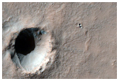 Fresh Small Impact Crater on Layered Bedrock
