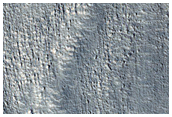 Ridges and Grooves in Flow on Moreux Crater Rim
