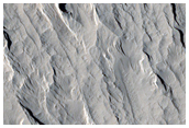 Layered Materials and Blocks in Olympus Mons Aureole