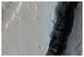 Hanging Crater Sliced by Graben in Tantalus Fossae
