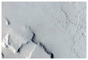 Raised Cluster Feature in Smooth Ceraunius Fossae Trough
