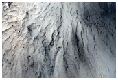 Distinct Bedrock Layer Exposed in Crater Rim North of Curie Crater
