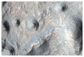 Eroded Layered Deposits on Floor of Large Crater